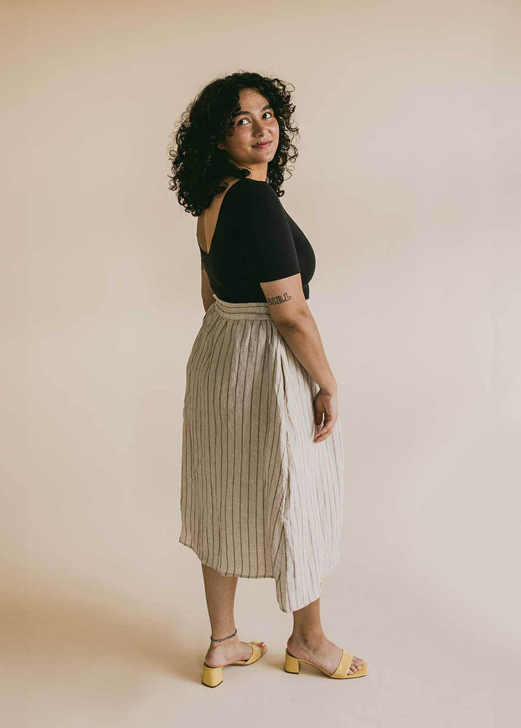 a mid size woman wearing a striped midi skirt