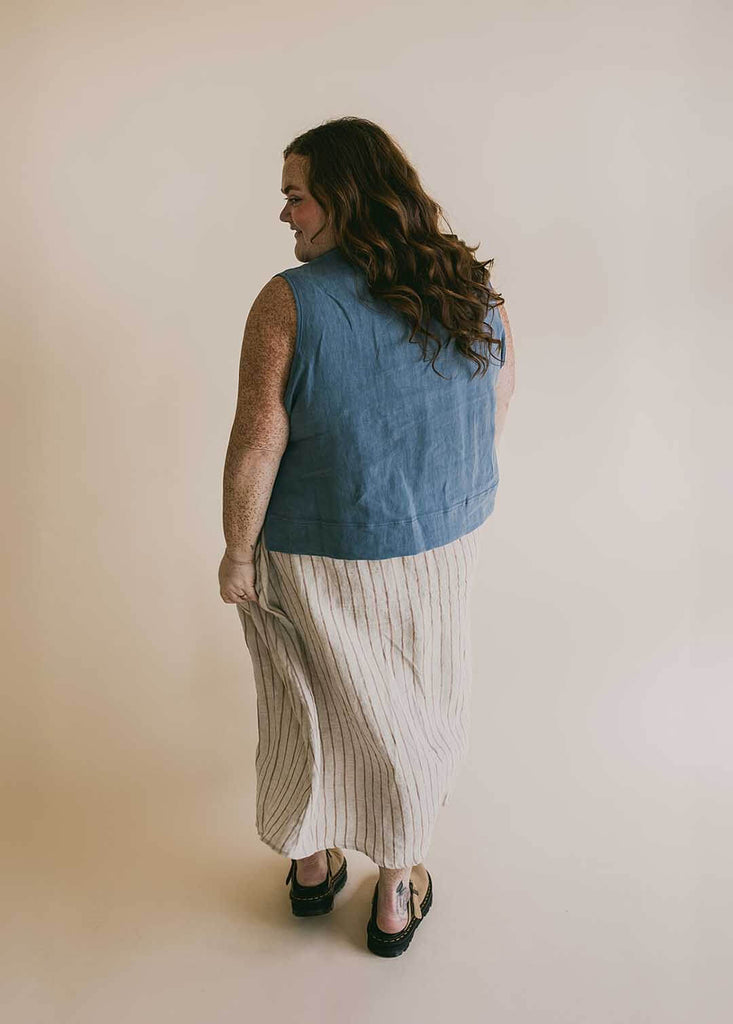 a plus size woman wearing a striped midi skirt