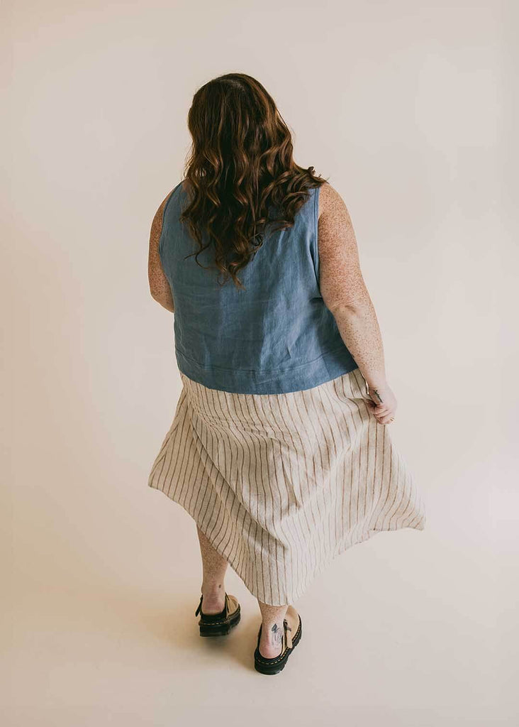a plus size woman wearing a striped midi skirt