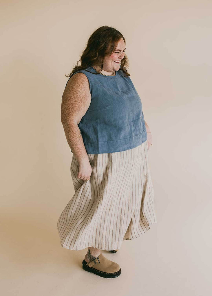 a plus size woman wearing a striped midi skirt