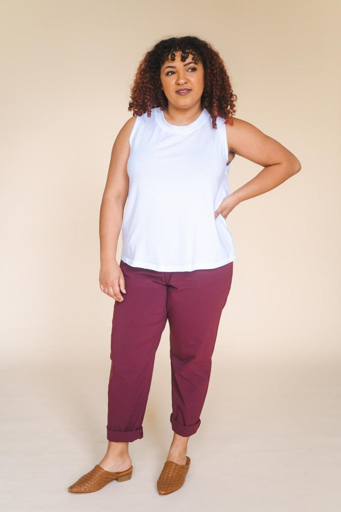 a mid size woman wearing a white tank top