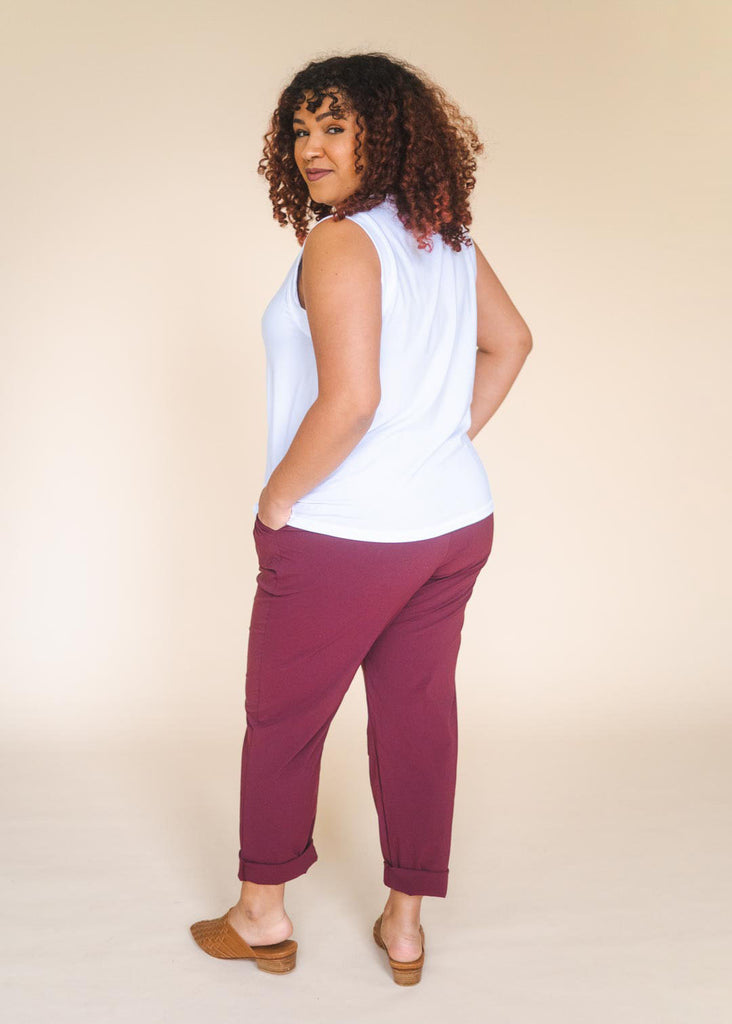 a mid size woman wearing a white tank top