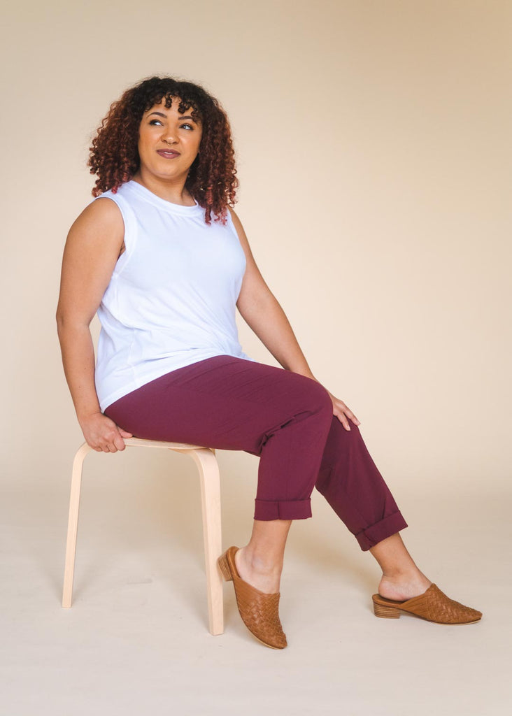 a mid size woman wearing a white tank top