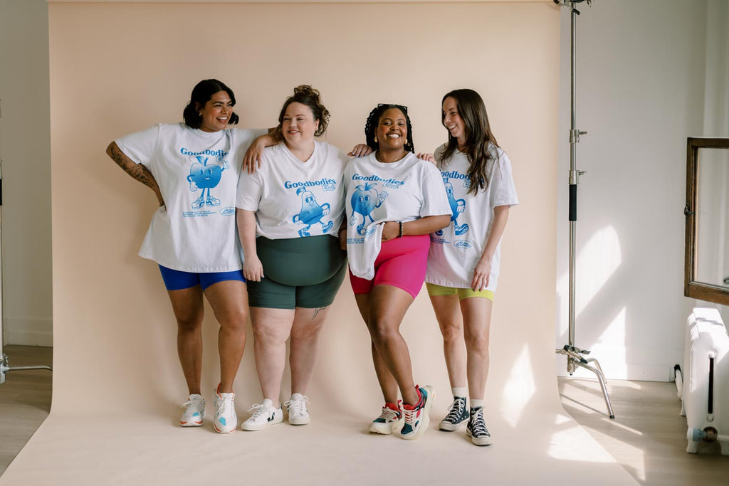 a group of women wearing graphic tees