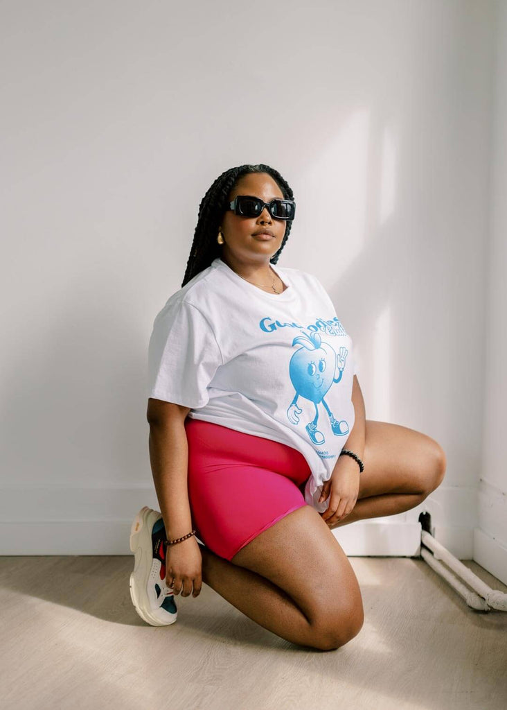 a woman kneeling while wearing pink bike shorts