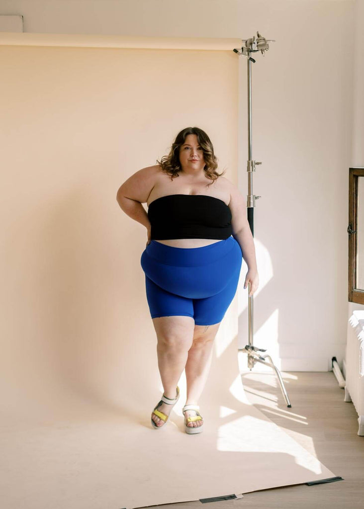 a plus size woman wearing blue bike shorts