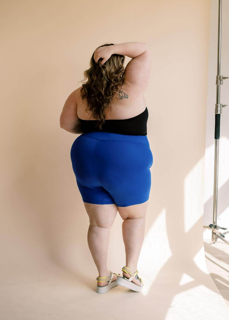 a plus size woman wearing blue bike shorts