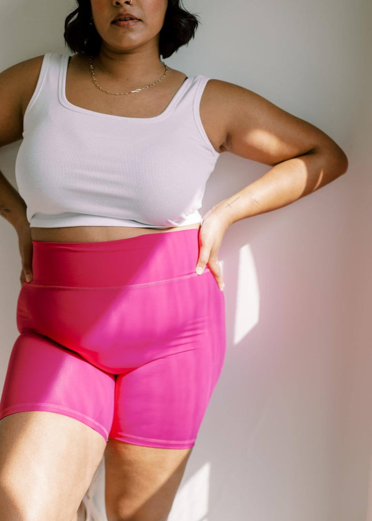 close up of a woman wearing pink bike shorts