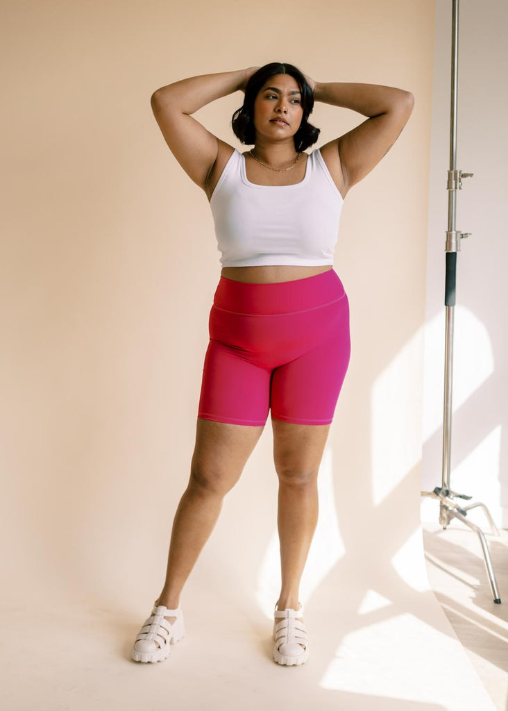 plus size woman wearing cropped white tank top