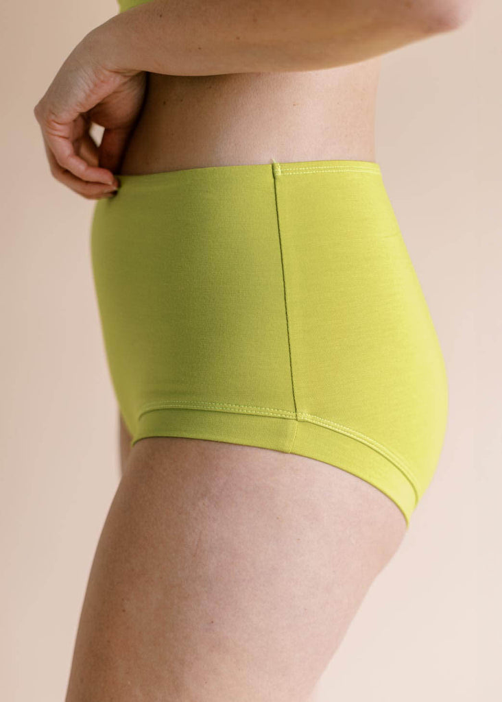 a close up of a  straight sized woman wearing green underwear