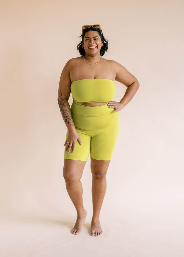 a plus size woman wearing a green bandeau