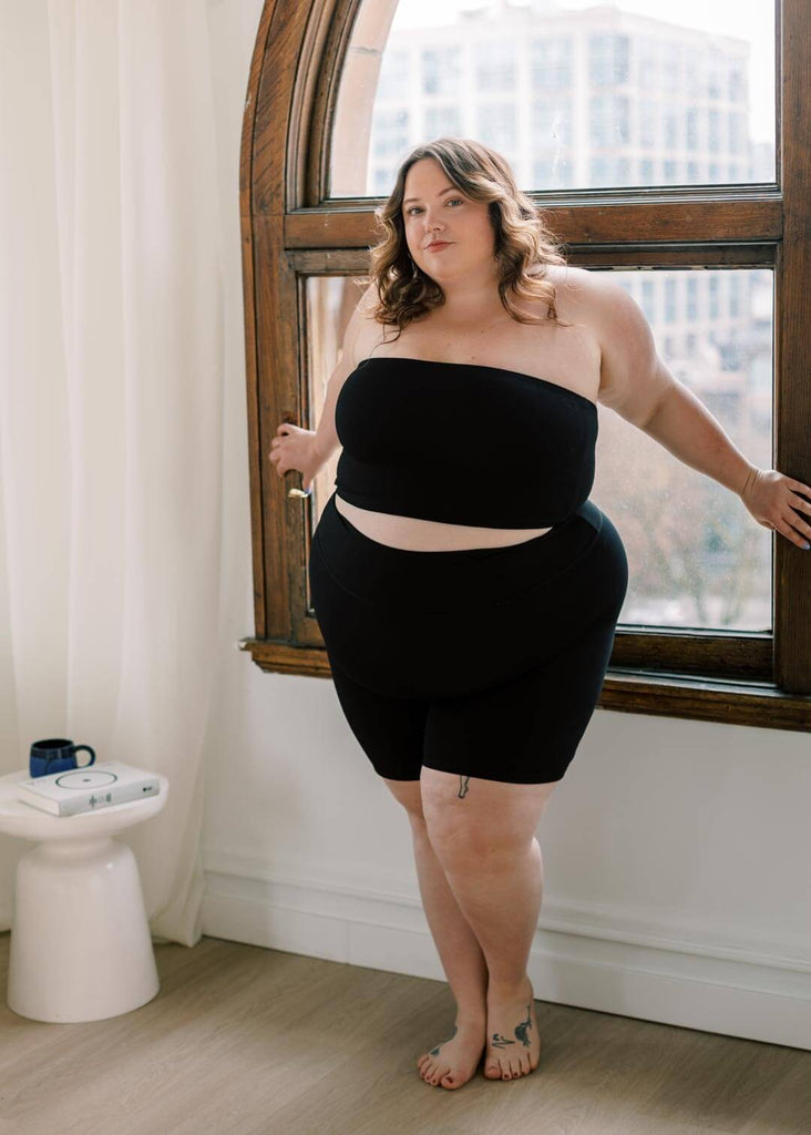 a plus size woman wearing a black bandeau