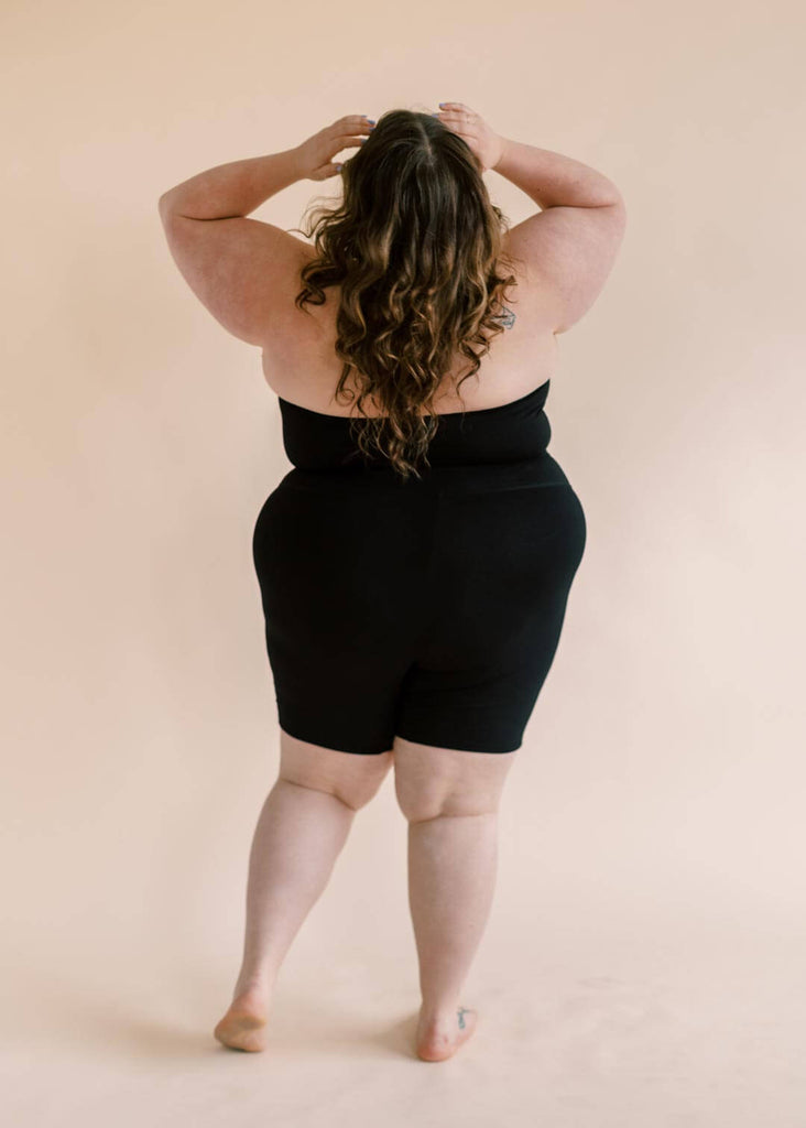 a plus size woman wearing a black bandeau