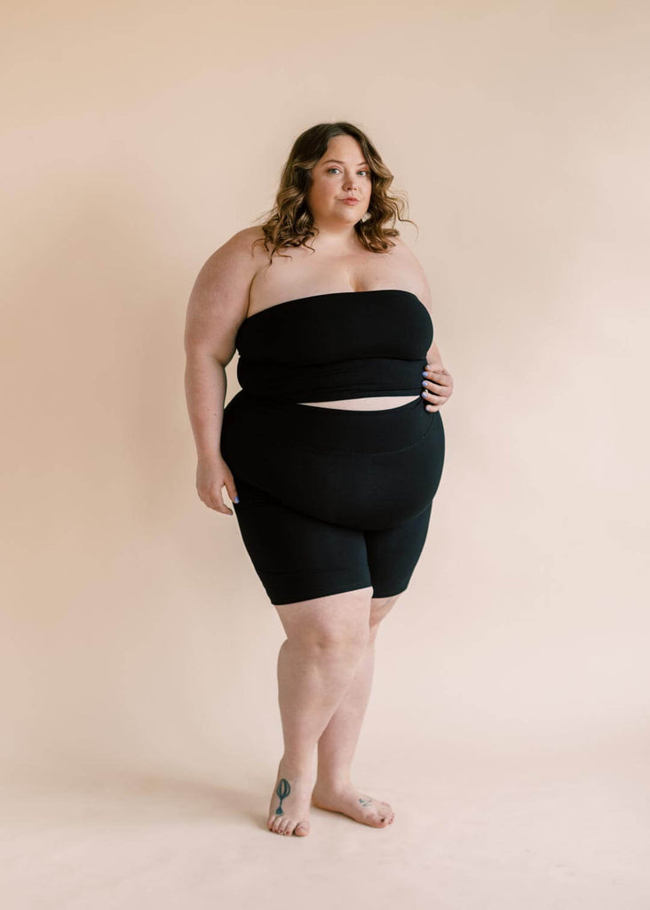 a plus size woman wearing a black bandeau