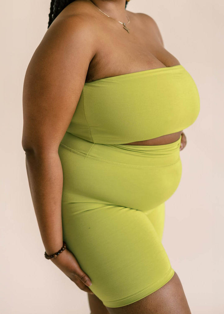 a close up of a plus size woman wearing a green bandeau