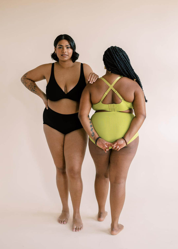 two woman wearing matching underwear sets