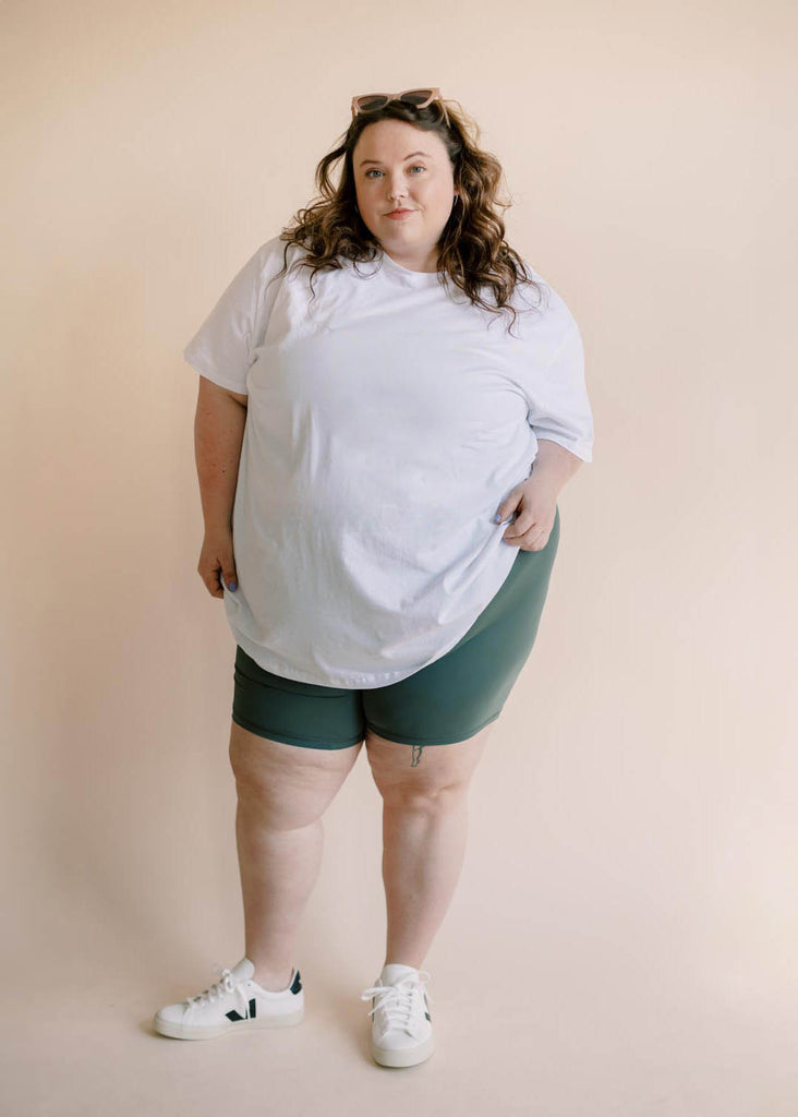 plus size woman in oversized white tee