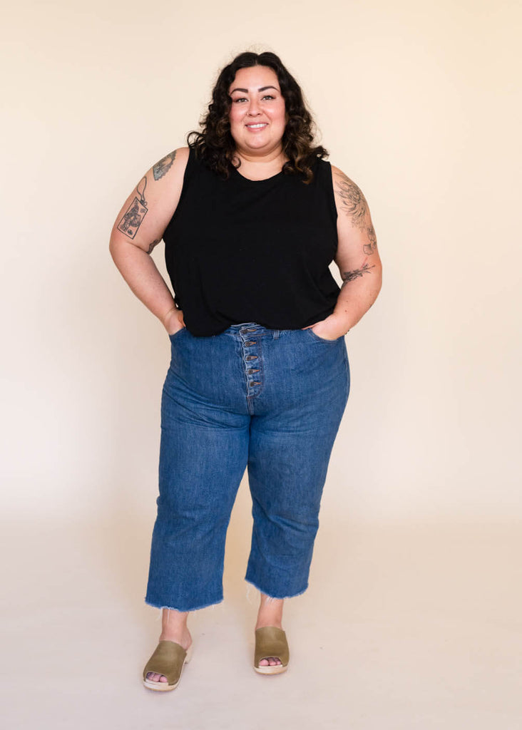 a plus size woman wearing a black tank top