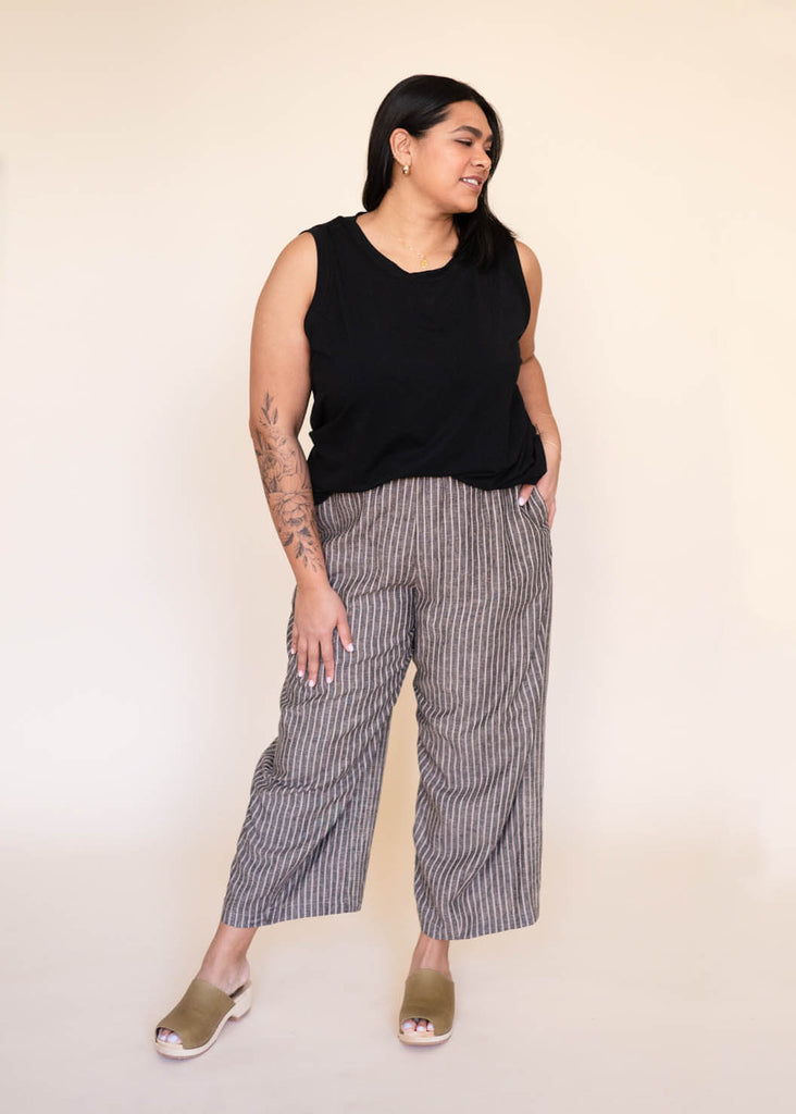 a mid size woman wearing a black tank top