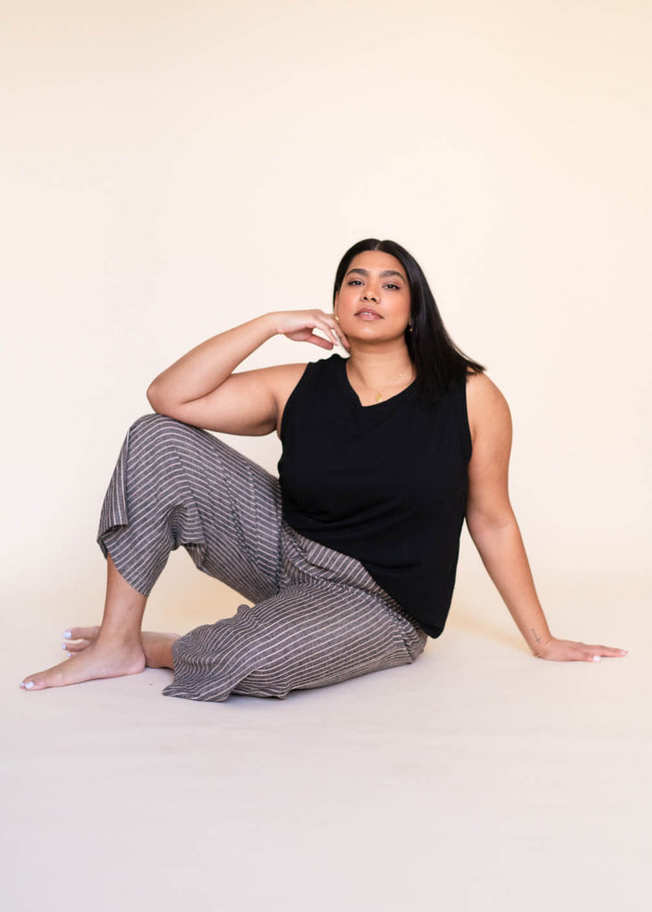 a mid size woman wearing a black tank top