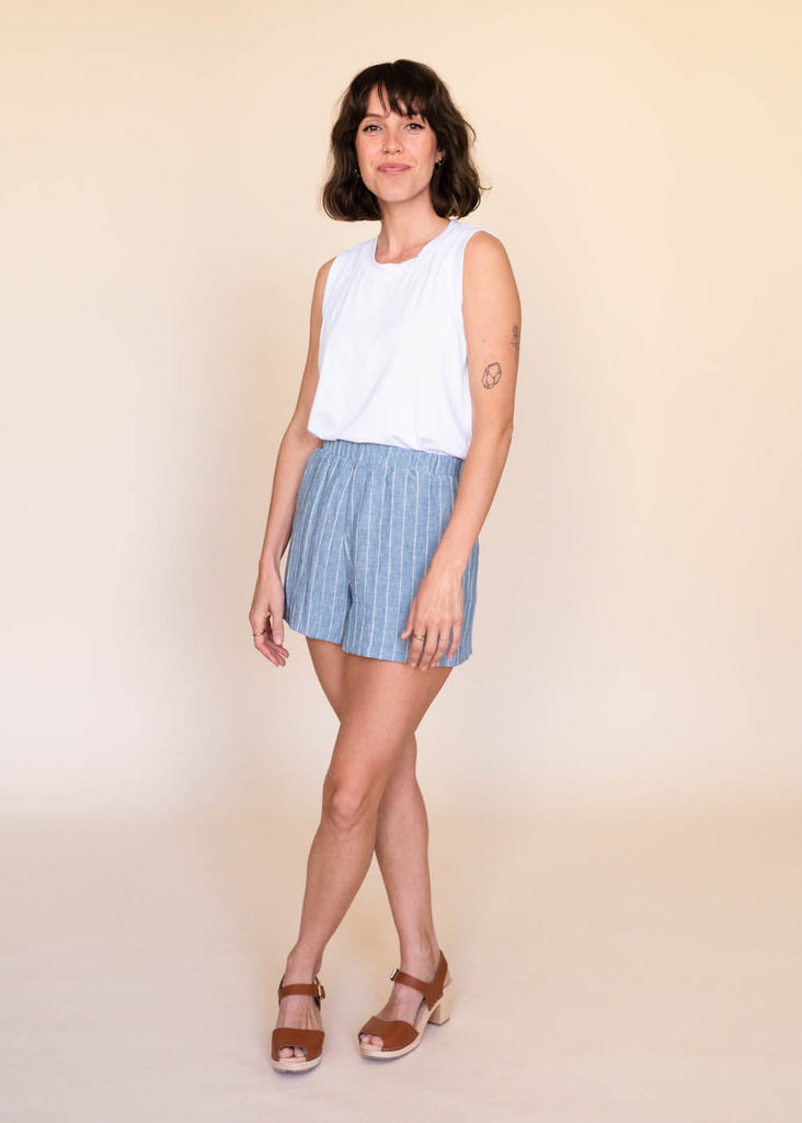 a straight size woman wearing a white tank top