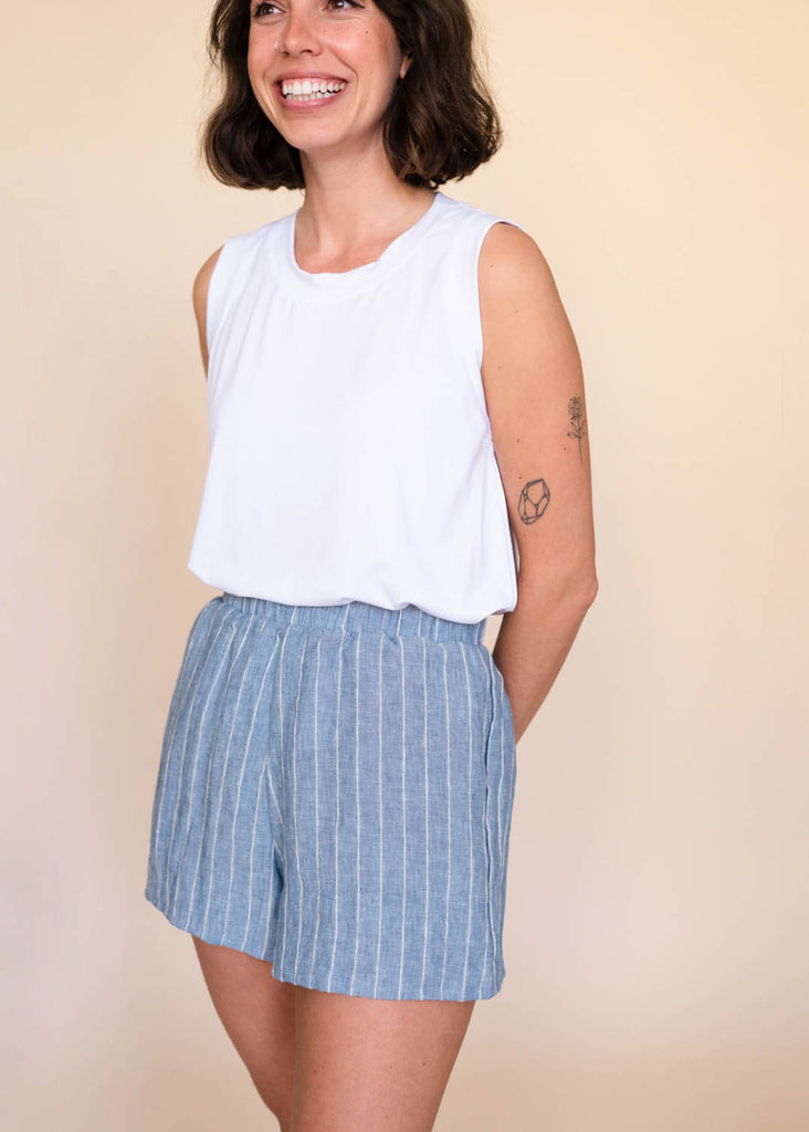 a straight size woman wearing a white tank top