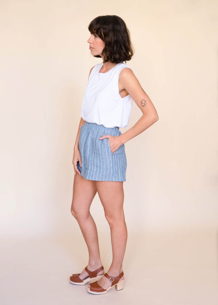 a straight size woman wearing a white tank top