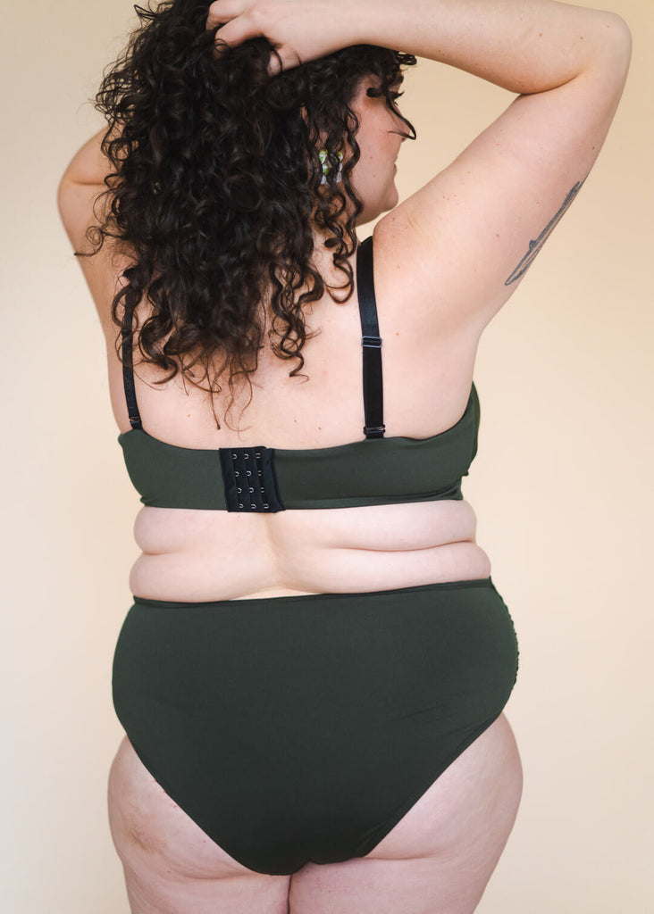 a plus size woman in a green bikini