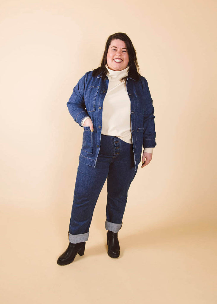 a plus size woman wearing a cream roll neck sweatshirt