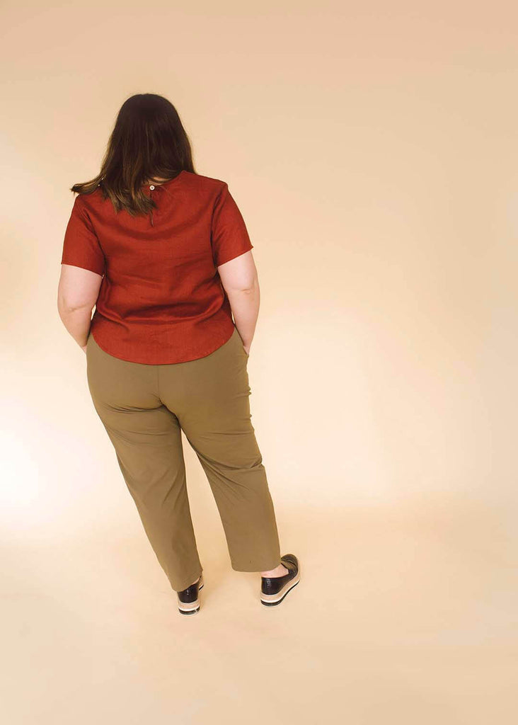 a plus size woman wearing tan tapered pants