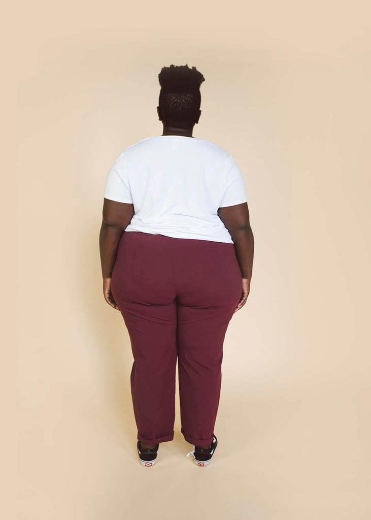 a plus size person wearing burgundy tapered pants